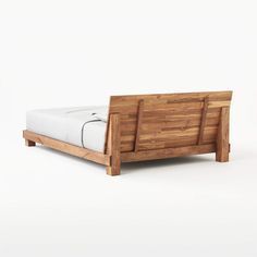 a bed made out of wood and white sheets