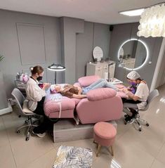 two women are getting their nails done in a salon with pink chairs and stools