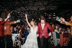 a bride and groom walk down the aisle as confetti is thrown in the air