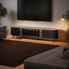 a large flat screen tv mounted to the side of a wall in a living room