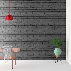 a room with a brick wall, chair and potted plant