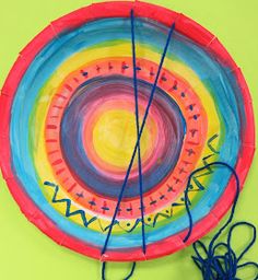 a colorful paper plate with string on it