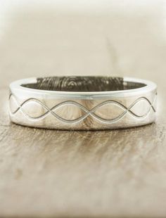 a close up of a wedding ring on a table