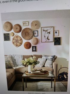 a living room filled with furniture and lots of pictures on the wall above it's coffee table