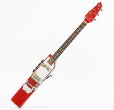 a red and white electric guitar with its case open on a white surface, in front of a white background