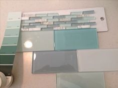 several different colors of glass tile on a counter top