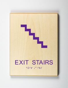 an exit stairs sign mounted on a wall