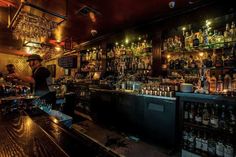 a bar with lots of liquor bottles on the shelves