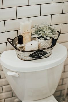 a white toilet sitting in a bathroom next to a tiled wall