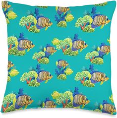 a blue pillow with an image of fish and broccoli on the bottom, in front of a turquoise background