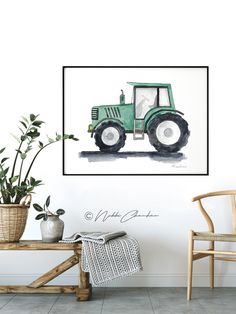 a green tractor is on the wall next to a chair and potted plant in front of it