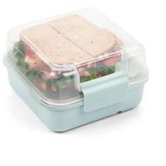 a plastic lunch box with a sandwich in it's lid on a white background