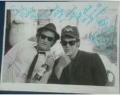 two men in hats and sunglasses posing for a photo