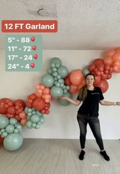 a woman standing in front of balloons with her arms spread out and the number 12 on it