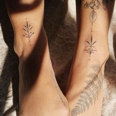 two people with tattoos on their legs and one has a flower tattoo on her leg