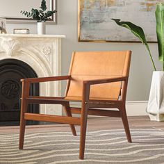 a wooden chair sitting in front of a fire place next to a potted plant