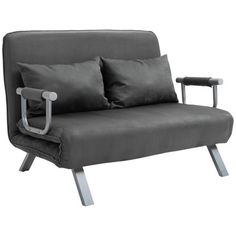 a gray couch with two pillows on top of it and a metal frame around the armrests