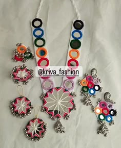 an assortment of colorful necklaces on a white sheet