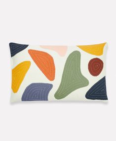 a rectangular pillow with colorful shapes on it