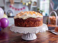 a cake with white frosting and orange zest sprinkles on top