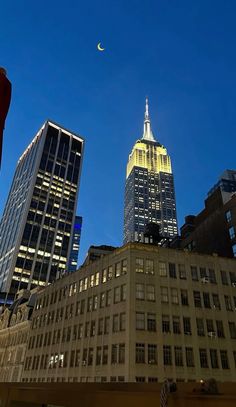 there is a very tall building in the city at night, and it's lit up