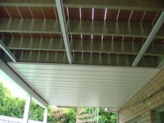 an outdoor covered patio with chairs and tables