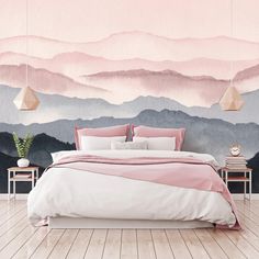 a bedroom with mountains painted on the wall and pink bedding, along with two nightstands