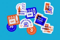 various stickers on a blue background that say duck's store