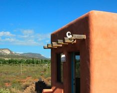 an adobe - style building with mountains in the background