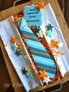 a birthday cake decorated like a tie and stars