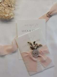 a close up of two wedding cards on a table