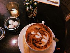 a cappuccino with marshmallows on the side