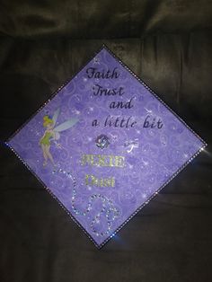 a purple graduation cap with the words faith trust and a little bit sparkle on it