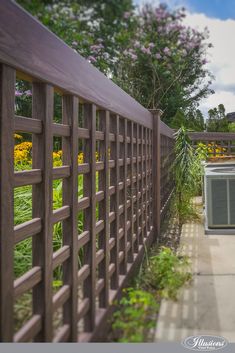 an air conditioner sitting on the side of a road next to a wooden fence