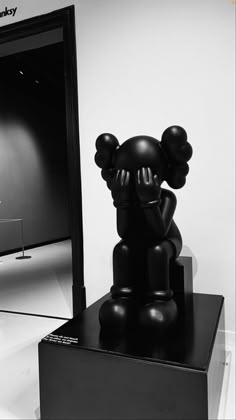 a black and white photo of a sculpture in front of a mirror with an elephant on it