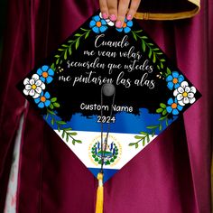 a person in a graduation cap and gown holding up a tassell with the words,