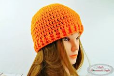 a mannequin head wearing an orange crochet hat