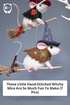 three mice are hanging from the ceiling and one has a witch hat on it's head