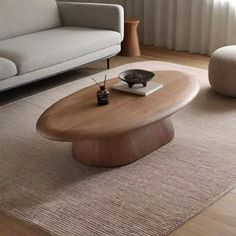 a living room with a couch, coffee table and chair