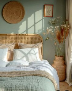 a bed with white linens and pillows in a bedroom next to a vase filled with flowers