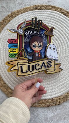 someone is holding up a harry potter badge