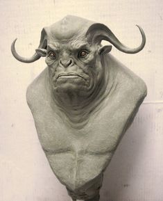 a statue of an evil looking creature with horns on it's head is shown