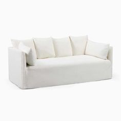 a white couch with four pillows on it