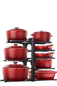 red pots and pans are stacked up on a black rack against a white background