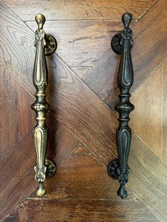 two ornate metal handles on wooden doors