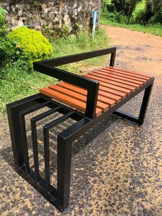 a wooden bench sitting on top of a dirt road