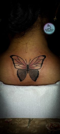 a woman with a butterfly tattoo on her back