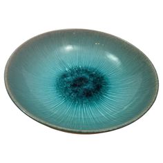 a blue glass bowl sitting on top of a white table