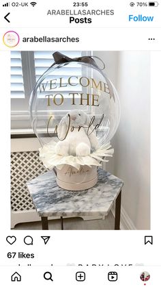 an image of a welcome to the world sign on top of a marble side table