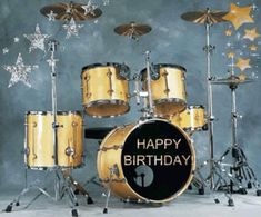 a drum set with happy birthday written on the front, and stars in the background